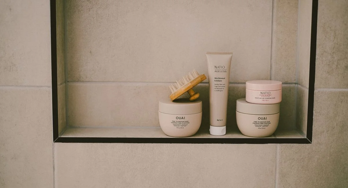 Explore a modern minimalist bathroom shelf with beauty products and hair care essentials in neutral tones.